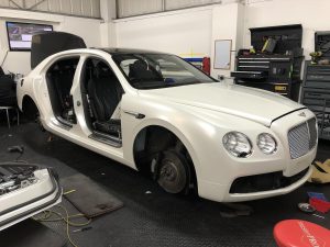 Car wrapping door shuts on a Bentley