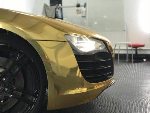 The front end of a gold wrapped Audi